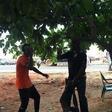 The brutalized okada man hanging on to the policeman's pants