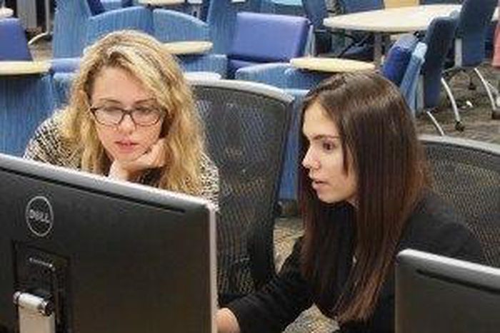 Emily Reid with a student at Girls Who Code