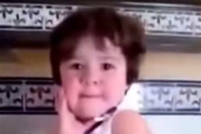 Crying baby girl immediately strikes a pose as soon as she sees a camera