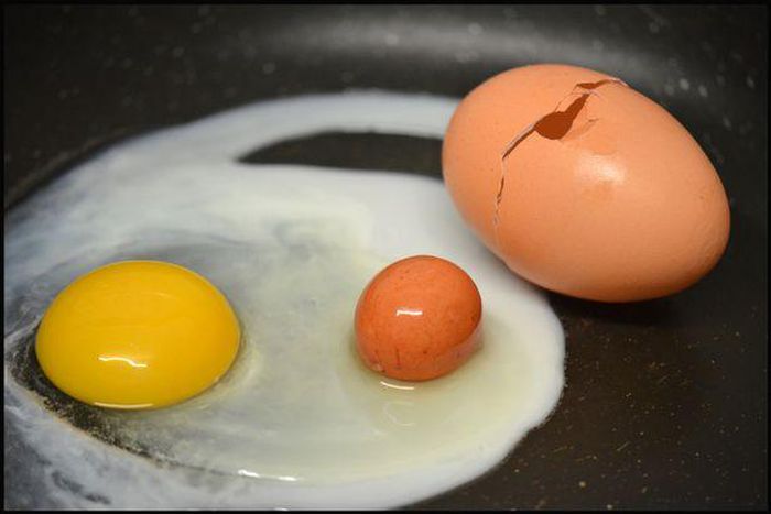Woman cracks open an egg and finds another one inside
