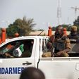 Gendarmes drive by anti-coup protesters in Ouagadougou, Burkina Faso, September 22, 2015. REUTERS/Joe Penney