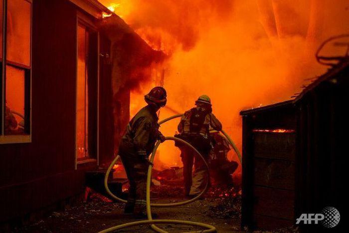 Thousands flee California wildfire as homes go up in flames