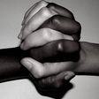 Interracial couple entwine hands