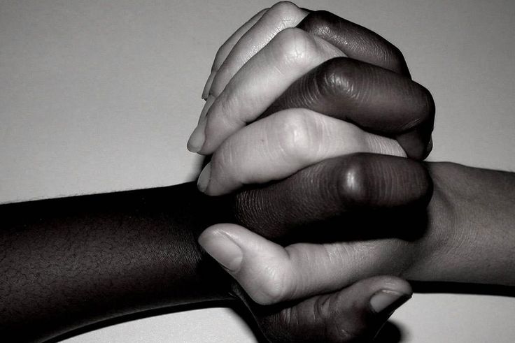 Interracial couple entwine hands