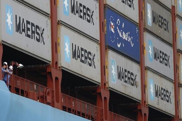 Crew members look out from the world's largest container ship, the MV Maersk Mc-Kinney Moller, as it berths during its maiden port of call at a PSA International port terminal in Singapore September 27, 2013. REUTERS/Edgar Su
