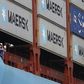 Crew members look out from the world's largest container ship, the MV Maersk Mc-Kinney Moller, as it berths during its maiden port of call at a PSA International port terminal in Singapore September 27, 2013. REUTERS/Edgar Su