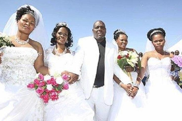 A happy groom with his brides
