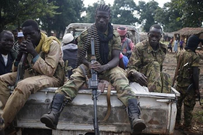 Seleka fighters take a break as they sit on a pick-up truck in the town of Goya June 11, 2014. REUTERS/Goran Tomasevic