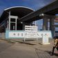 People walk by the National Arts Theatre stop of the light rail system under construction in Lagos, Nigeria, May 30, 2014. REUTERS/Joe Penney