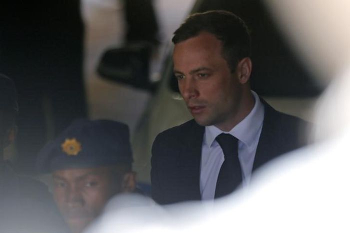 South African Olympic and Paralympic sprinter Oscar Pistorius is led to a prison van after his sentencing in Pretoria October 21, 2014. REUTERS/Mike Hutchings