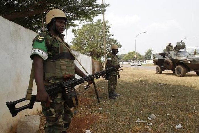 Members of the African peacekeeping forces stand in a street in Bangui February 19, 2014. REUTERS/Luc Gnago