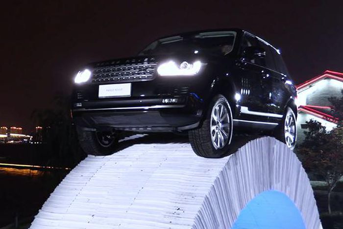 Range Rover SUV on the paper bridge