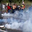 Hungarian police fire water cannon and tear gas at migrants