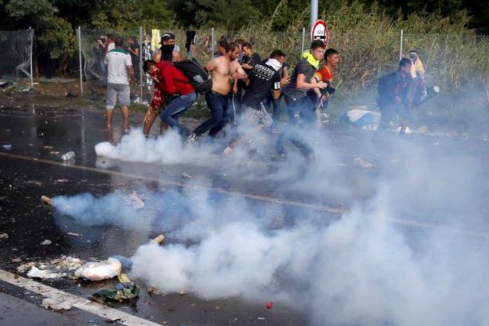 Hungarian police fire water cannon and tear gas at migrants