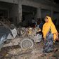 A Somali woman walks past the scene of a suicide car bomb attack near Juba hotel in capital Mogadishu August 22, 2015.  REUTERS/Feisal Omar