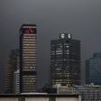 The logos of South Africa's three biggest banks, ABSA, Standard Bank and First National Bank (L-R), adorn buildings as winter storms hit Cape Town, July 8, 2015.  REUTERS/Mike Hutchings