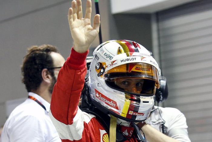 Ferrari Formula One driver Sebastian Vettel of Germany reacts after qualifying for the Singapore F1 Grand Prix at the Marina Bay street circuit September 19, 2015. Vettel broke Mercedes' qualifying stranglehold to secure a first pole position of the se...