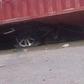 The crushed car underneath the trailer (Illustration)