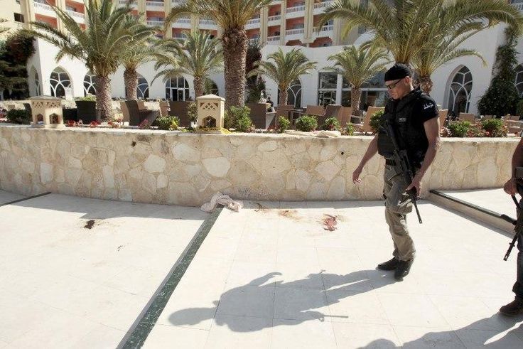 A police officer walks past blood at the Imperiale Marhaba hotel after a gunman opened fire at the beachside hotel in Sousse, Tunisia June 26, 2015.   REUTERS/Zoubeir Souissi