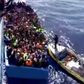 A boat full of migrants is seen next to Swedish ship Poseidon during a rescue operation in the sea off the coast of Libya in this still image taken from an August 26, 2015 video. REUTERS/Swedish Coast Guard Handout via Reuters TV