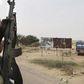 Chadian soldiers drive past a signpost painted by Boko Haram in the recently retaken town of Damasak, Nigeria, March 18, 2015. REUTERS/Emmanuel Braun