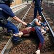 Migrant family protest on train tracks to avoid refugee camp and Hungarian police men