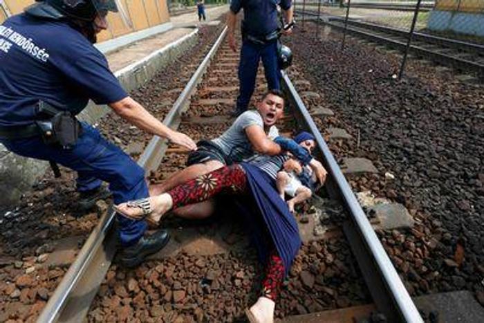Migrant family protest on train tracks to avoid refugee camp and Hungarian police men