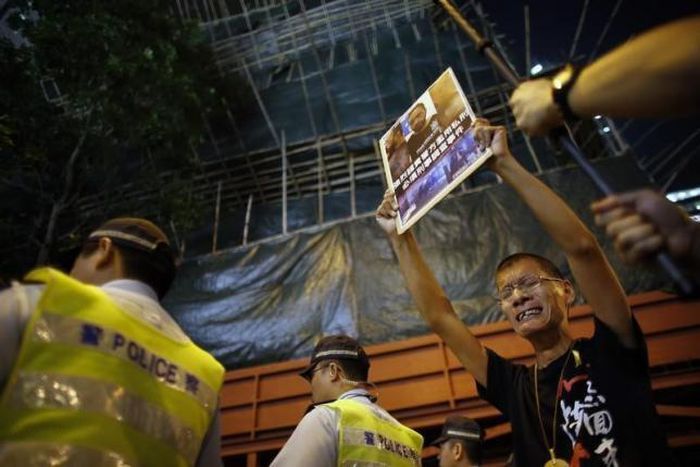 Police charged over beating of democracy activist