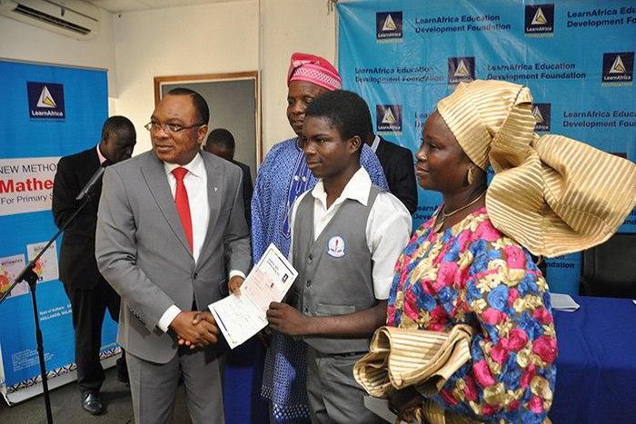 MD/CE,Learn Africa Plc, presenting award certificate to Mst.Folorunso Temitope of Ota Total Academy as second best  candidate, Ogun State.