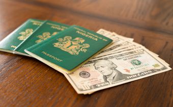 Nigerian Passport with United State Dollars for vacation or business trip. [Stock Photo/Getty Images]