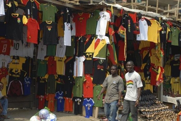 People walk past football memorabilia for sale at a vendor's stall in Ghana's capital Accra  in a file photo.   REUTERS/Yaw Bibini