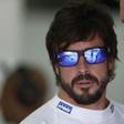 McLaren's Fernando Alonso (L) speaks to a crew member before practice for the Malaysian Grand Prix. Reuters / Olivia Harris