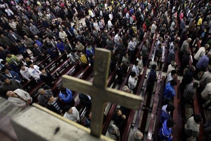 Worshippers pray during a mass at the Liuhe Catholic Church in Liuhe village on the outskirts of Qingxu county, northern China, in this undated photo