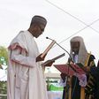 Chief Justice of Nigeria Mahmud Mohammed swears in Muhammadu Buhari (C) as Nigeria's president while Buhari's wife Aisha looks on at Eagle Square in Abuja, Nigeria May 29, 2015. REUTERS/Afolabi Sotunde