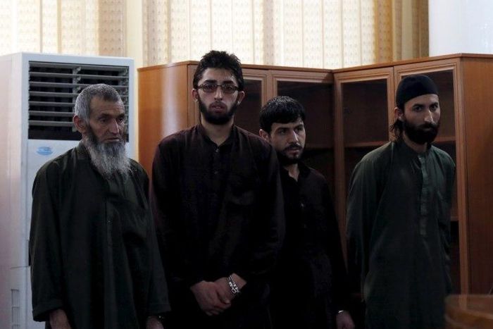 Four Afghan men look on in court during their trial in which they were sentenced to death for killing a 27-year-old woman, in Kabul, Afghanistan