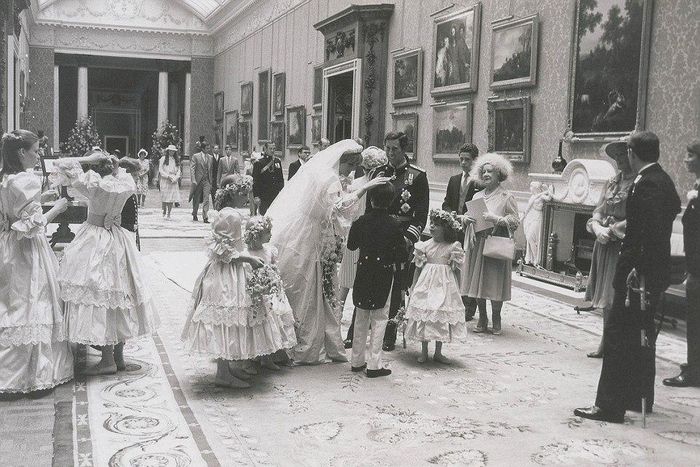 The newly-married couple stop to speak to their page boys and bridesmaids as the Queen Mother (right) looks on