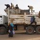 Nigeriens, who are travelling north towards Libya, board a truck in Agadez March 17, 2014. Picture taken March 17, 2014. To match Special Report EUROPE-IMMIGRATION/NIGER REUTERS/Joe Penney