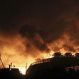 Vehicles are seen burning after blasts at Binhai new district in Tianjin municipality, China, on Thursday.
