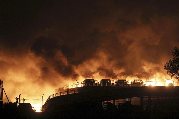 Vehicles are seen burning after blasts at Binhai new district in Tianjin municipality, China, on Thursday.