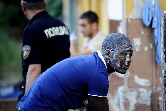 A migrant washes himself at a train station in Demirkapija near the Greek border June 17, 2015. REUTERS/Ognen Teofilovski