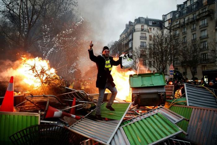In Paris, yellow vest protesters set up burning barricades as they took to the streets for another Saturday protest against Macron's pro-market policies