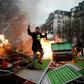 In Paris, yellow vest protesters set up burning barricades as they took to the streets for another Saturday protest against Macron's pro-market policies