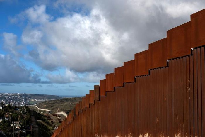 A section of the steel wall on the US - Mexico border near San Diego, California