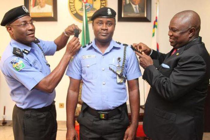 Lagos State Governor, Akinwunmi Ambode decorates his Chief Security Officer (CSO), Saheed Kassim on Tuesday, August 11, 2015.