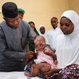 Vice President, Yemi Osinbajo with a child injured in a Boko Haram attack.