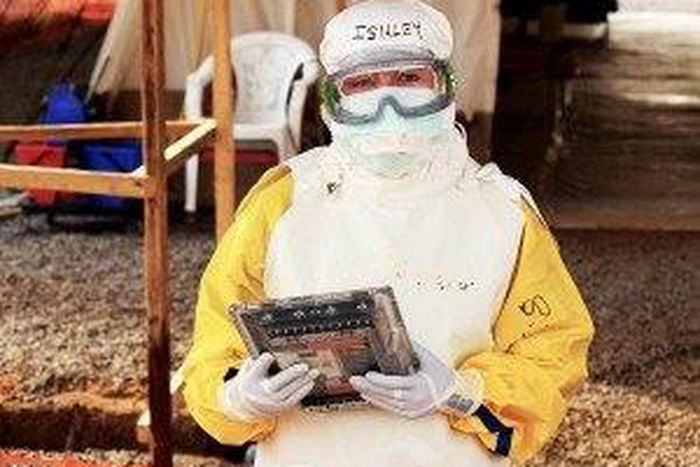 health care worker holding Ebola proof tablet
