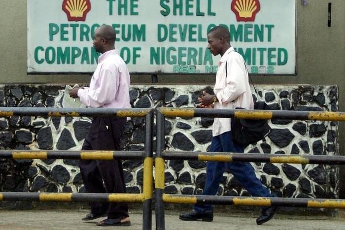 People walk past the Dutch oil giant Shell's sign board in Port Harcourt in the volatile Niger delta region of Nigeria, in a file photo. REUTERS/George Esiri