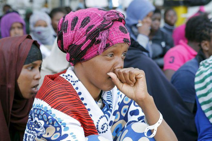 A rescued female migrant waits with others to disembark as they arrive at Pozzallo harbour, Italy, June 9, 2015. REUTERS/Antonio Parrinello