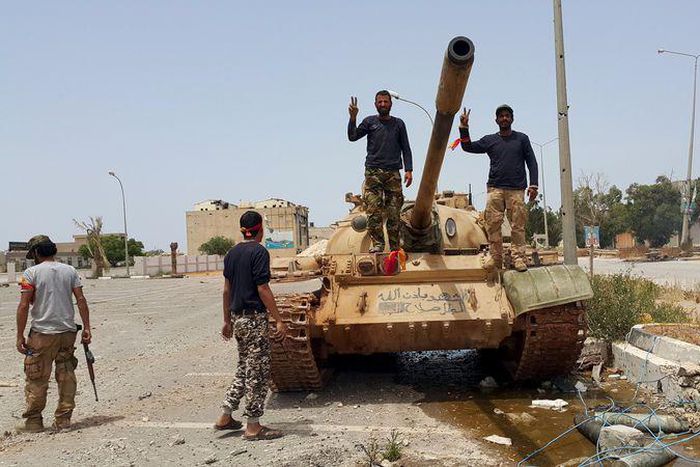 Members of the Libyan pro-government forces gesture as they stand on a tank in Benghazi, Libya, May 21, 2015. REUTERS/Stringer