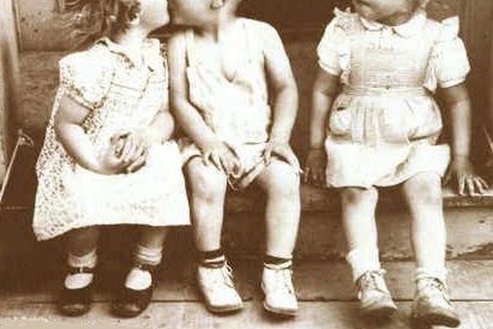 Three children act out jealous scene